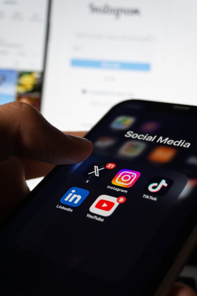 0cpyfssuisc - How to Use Social Media to Attract More Martial Arts Student A person holding a smart phone with social media on the screen
