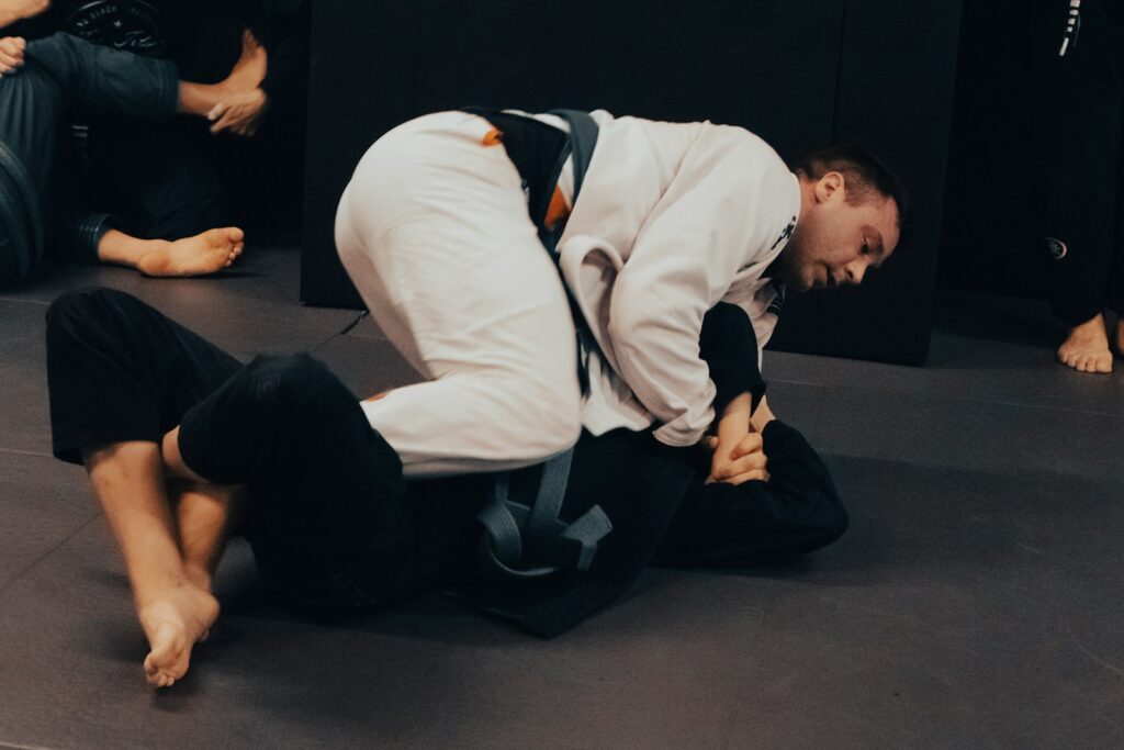 57wvquqgga4 - So far, so good. a man in white shirt and black pants on a black mat