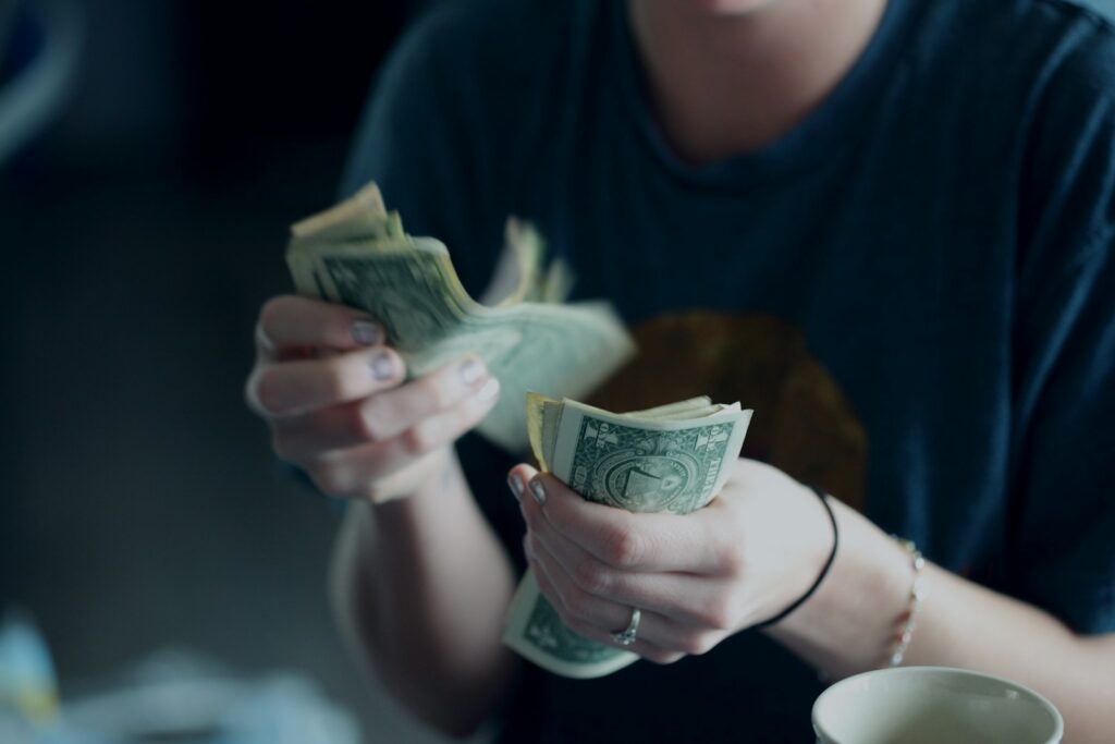 8a5ej1 mmq - How to Reduce Payment Failures and Improve Cash Flow in Your Martial Arts Business focus photography of person counting dollar banknotes