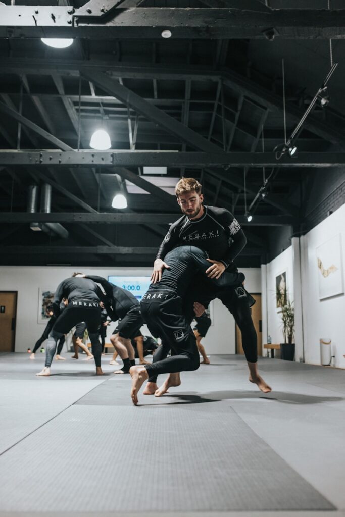 9bkvz3iiff8 - How to Grow Your Martial Arts School With Effective Student Retention Strategies woman in black and white long sleeve shirt and black shorts running on gray concrete floor