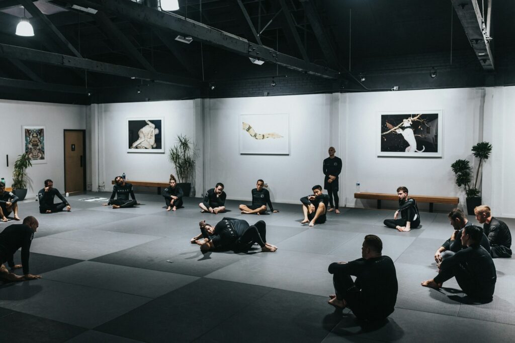 dt3bb kdaus - How to Keep Martial Arts Students Motivated All Year Round people sitting on floor in front of white wall