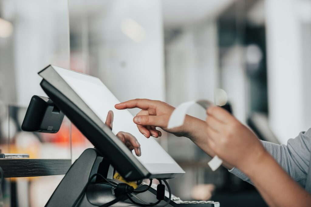 gkndm1gvsa - How to Manage Direct Debits for Gym Payments a person is using a pos machine in a store