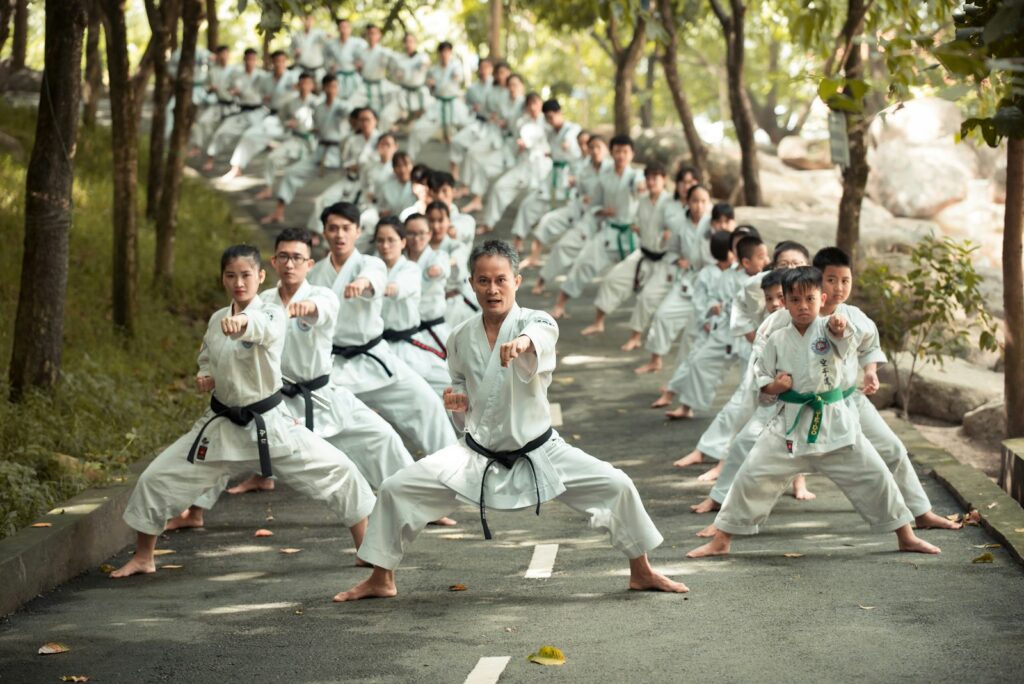 hhechvrihf8 - How to Use Events to Grow Revenue in Your Martial Arts School people in white uniform sitting on gray concrete road during daytime