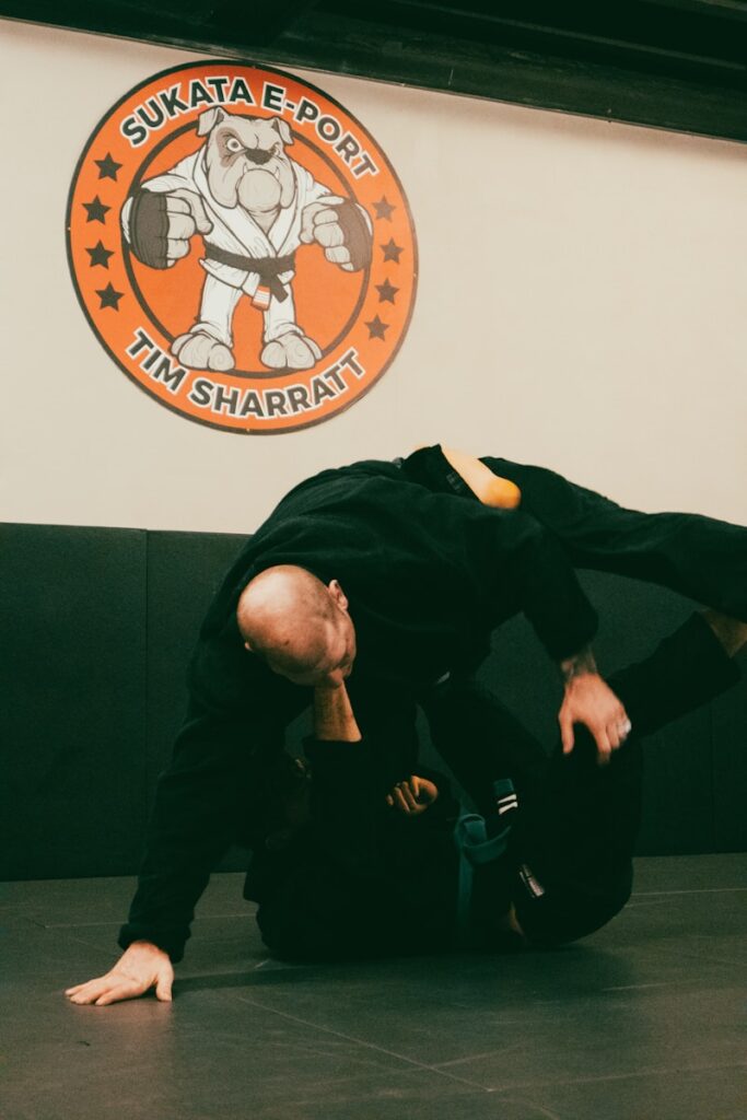 kna0eriu5ya - The Importance of Financial Planning for Martial Arts School Owners a man in black shirt doing a trick on a black mat