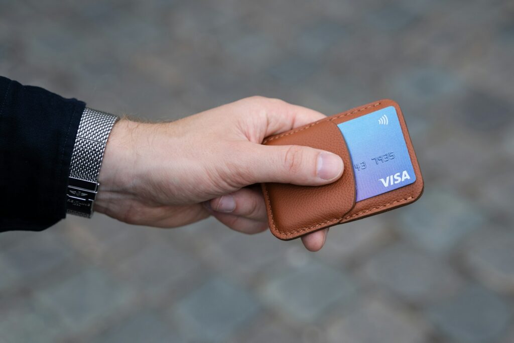 norks1slsbi - How to Reduce Payment Failures in Martial Arts Schools a hand holding a wallet with a credit card in it