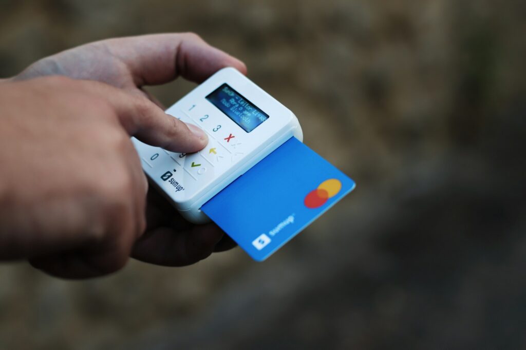 pxn3kovrxmi - How to Automate Membership Fee Collection Using Direct Debit a hand holding a credit card and a cell phone
