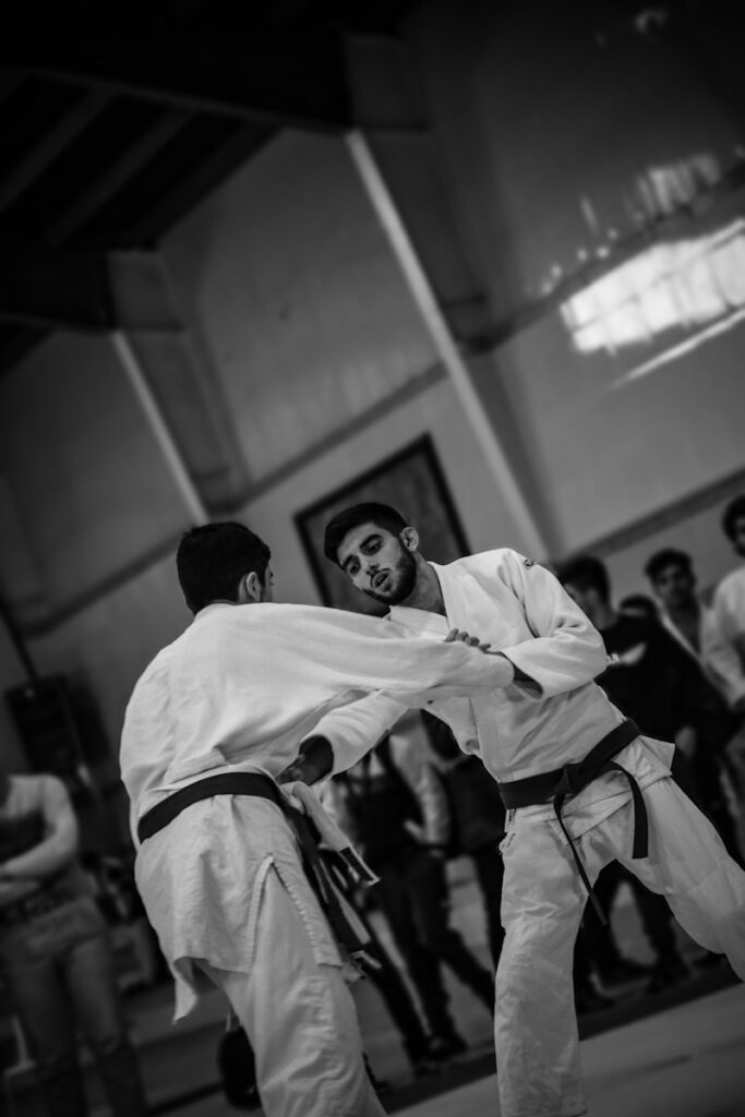 qyrl2cpvlok - Student Feedback Systems: How Top Martial Arts Schools Continuously Improve A couple of men standing next to each other in a room