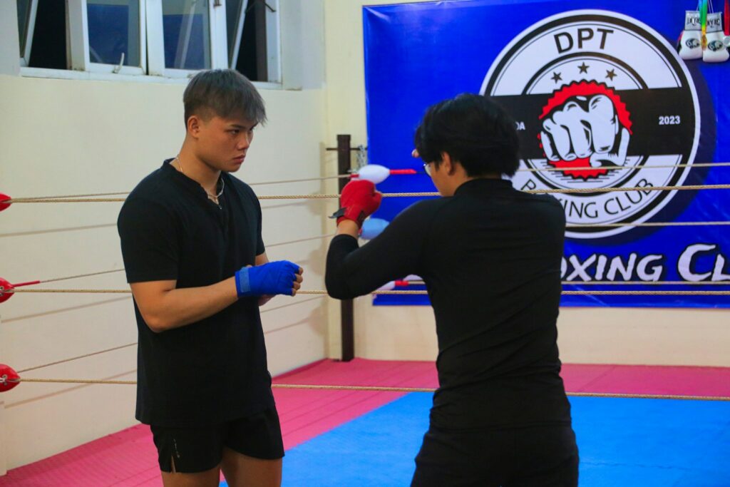 a man and a woman standing in a boxing ring