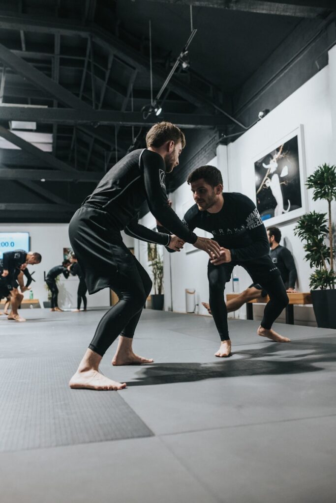 yqg2wxjainq - How to Improve Retention for Martial Arts Gyms man in black long sleeve shirt and black pants doing push up
